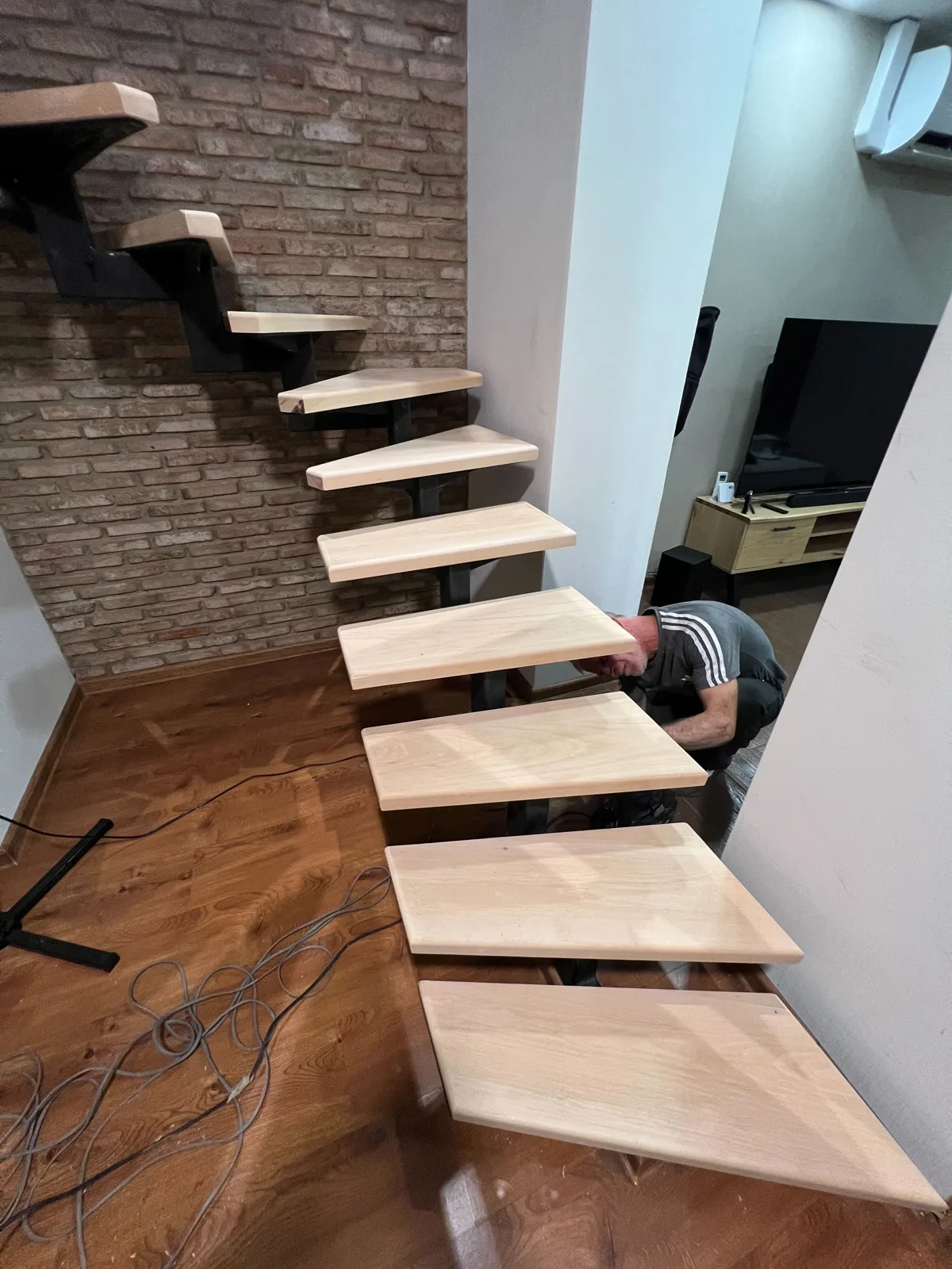 Floating staircase with exposed brick wall